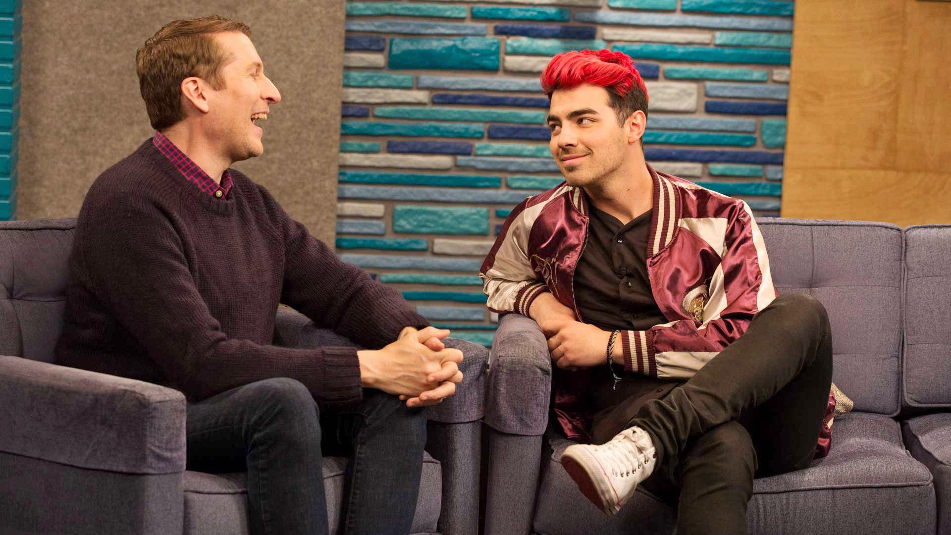 Still from Joe Jonas Wears a Maroon and Gold Letterman Jacket With White Sneakers